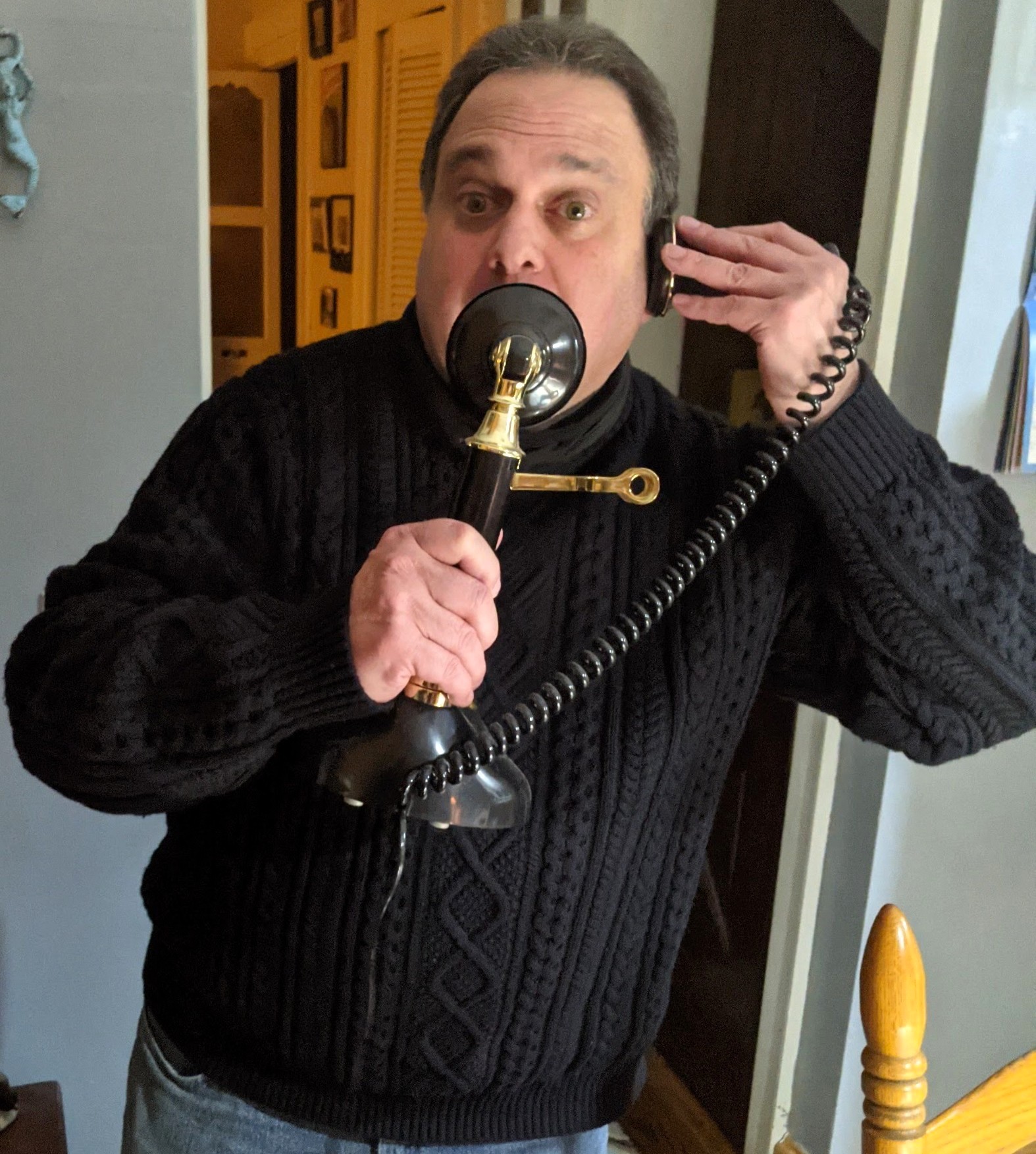 Jay holding an antique telephone